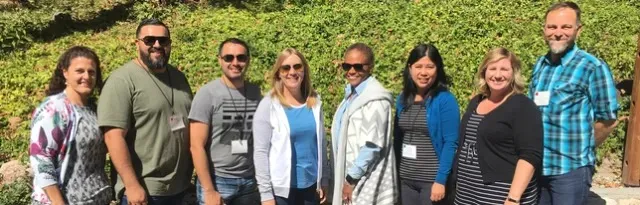 Group of employees smiling for the camera.