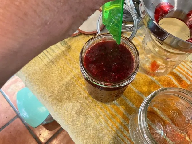 Measuring jam headspace in a jar.