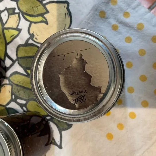 A close up of water that has pooled on a lid of a jar.
