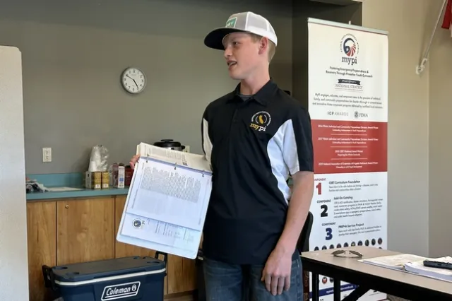 Young man speaks in front of the group at a training workshop