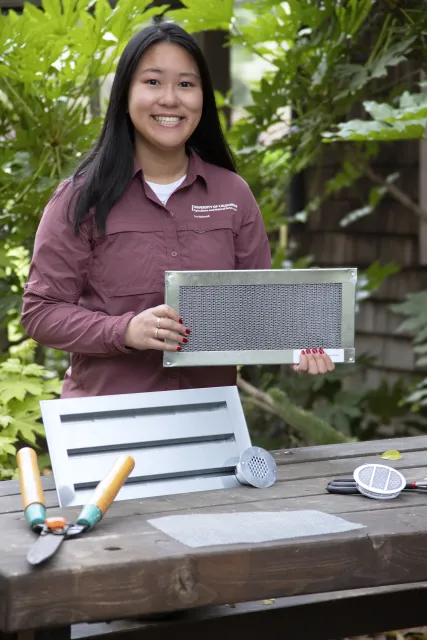 Katie Low shows a vent screen for hardening a home from fire