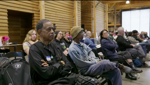 People sitting in chairs in rows.