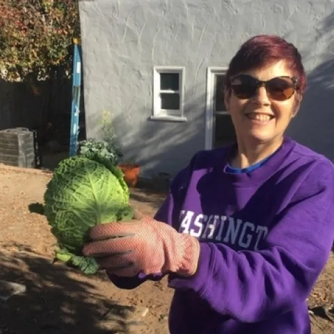 Elaine Silver, CFHL UCCE Educator who works with JobTrain pictured with a head of cabbage
