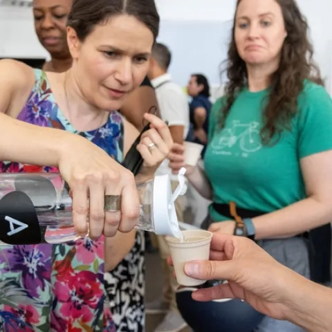 Edith de Guzman pours a sample of water for a taste test