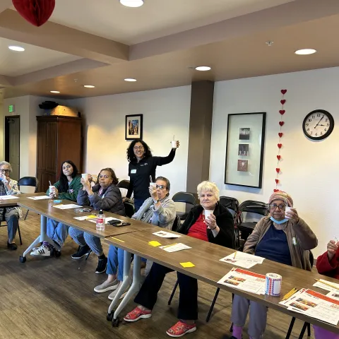 Ingrid Alarcón poses with community members at Oaks on Florence senior center during a nutrition class