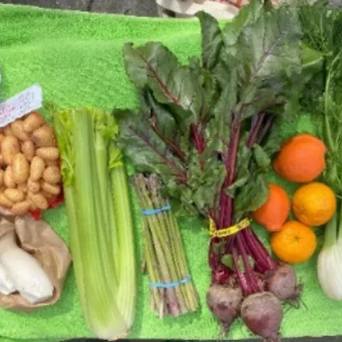 A collection of fresh produce laid out on a green towel.