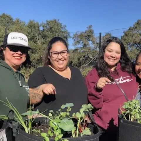 Women celebrating their new portable edible garden bags